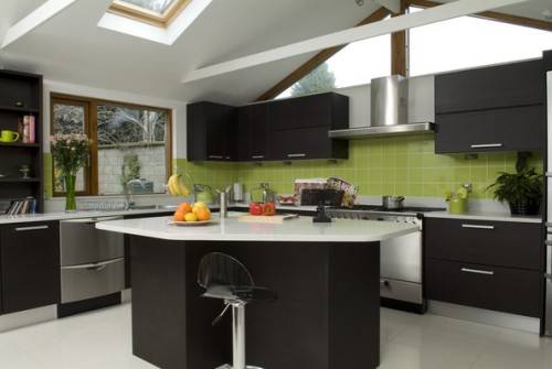Black kitchen cabinets and green walls