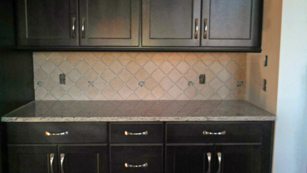 Dark cabinets tile backsplash