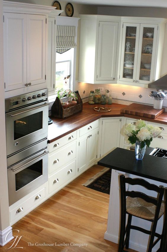 White Kitchen Interior with Wooden Countertop photo - 8