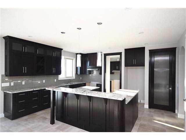 black kitchen cabinets and gray walls photo - 3