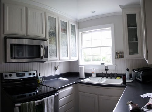 black kitchen cabinets and white appliances photo - 6