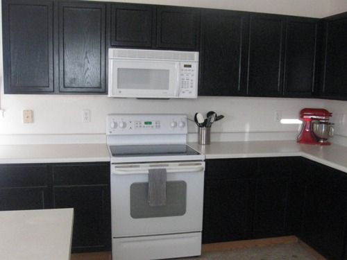 black kitchen cabinets and white appliances photo - 8