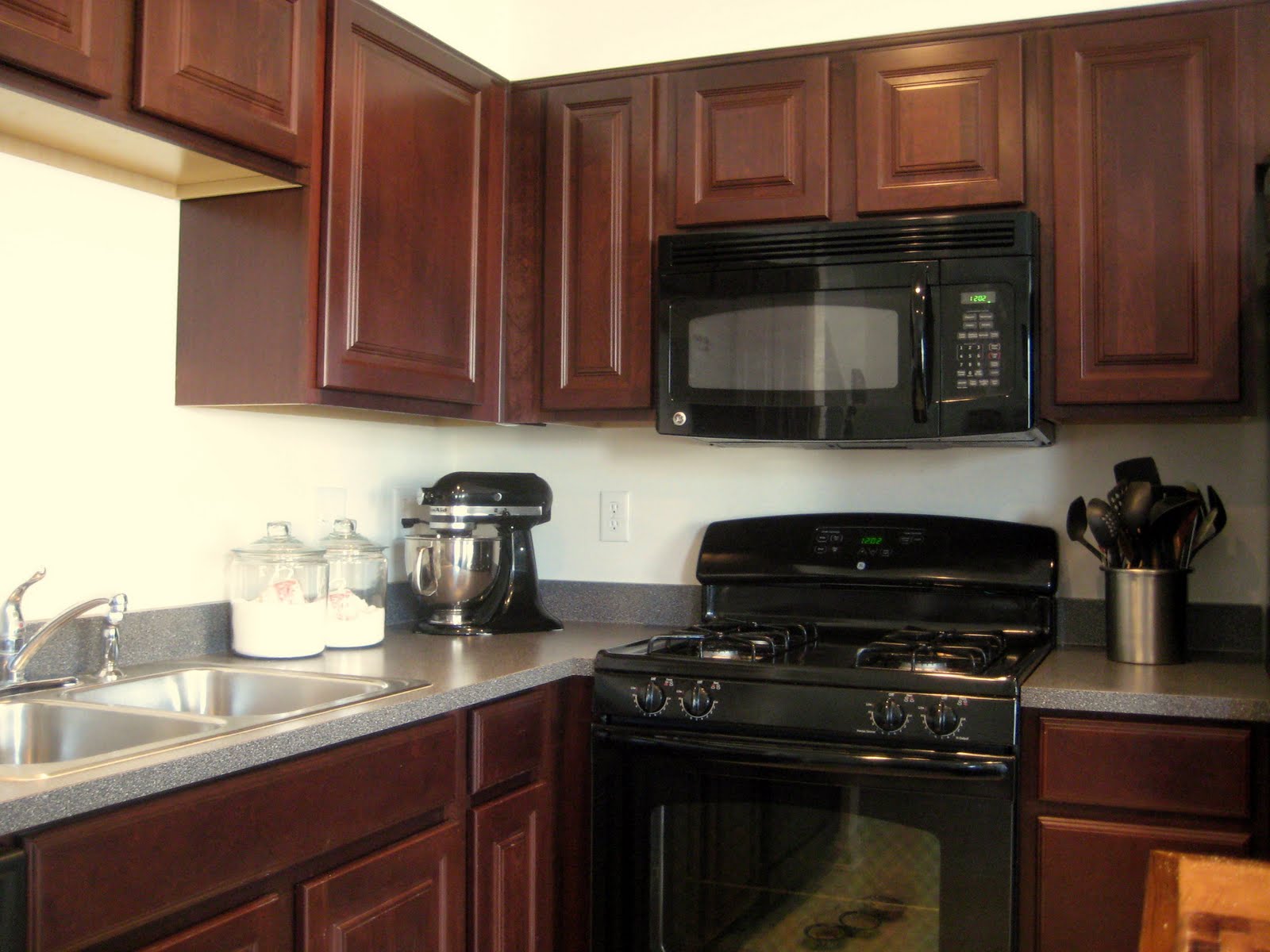 black kitchen cabinets with black appliances photo - 5