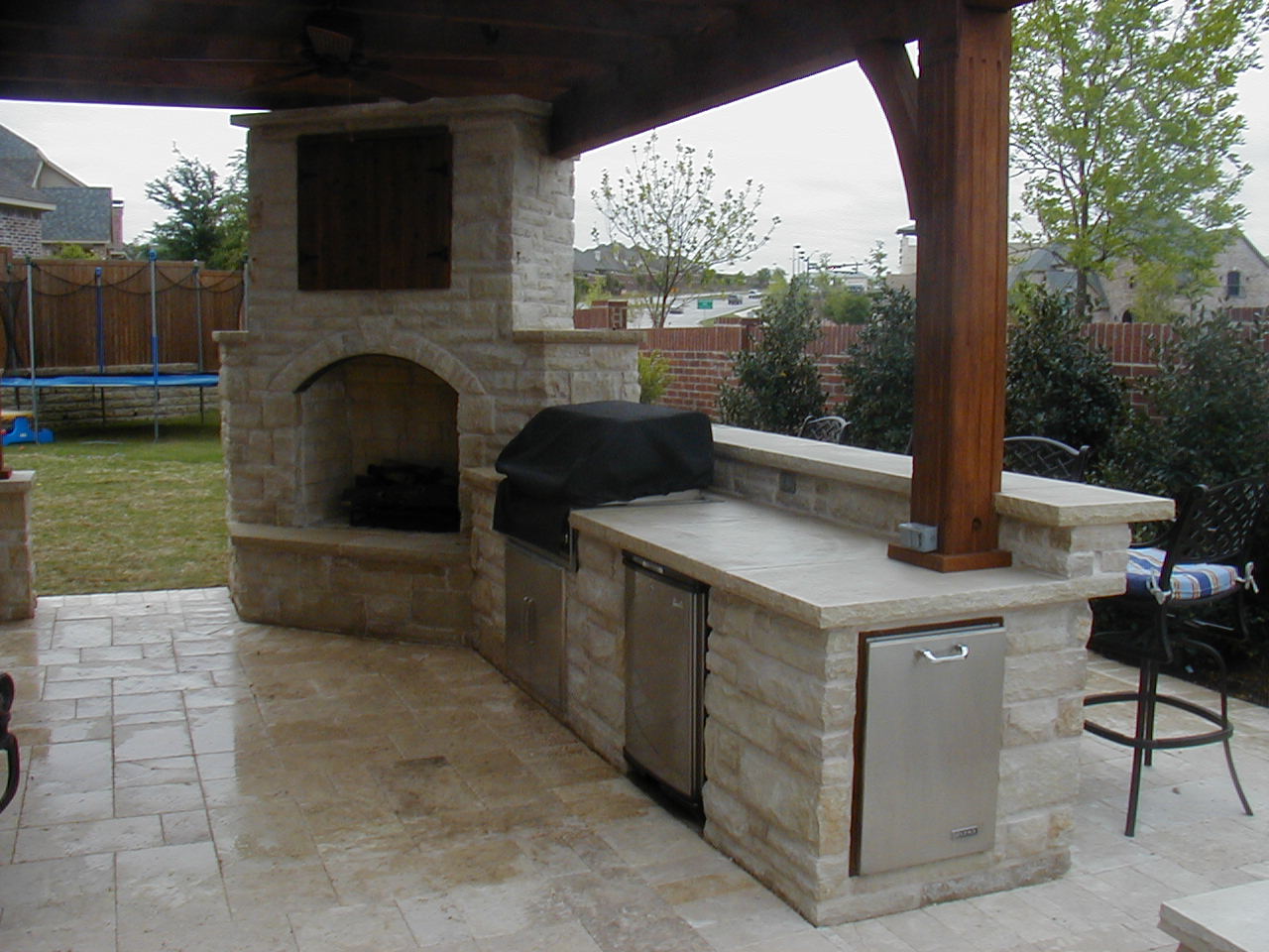 outdoor kitchen and fireplace photo - 3